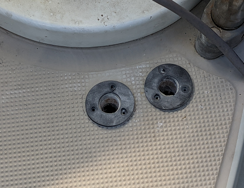 Two 9/16" holes drilled in the deck with gaskets around them