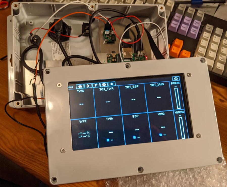 Software running on a touchscreen, mounted to a plastic case lid. The lid is connected to the system internals by wires but the lid is not attached to the case body.