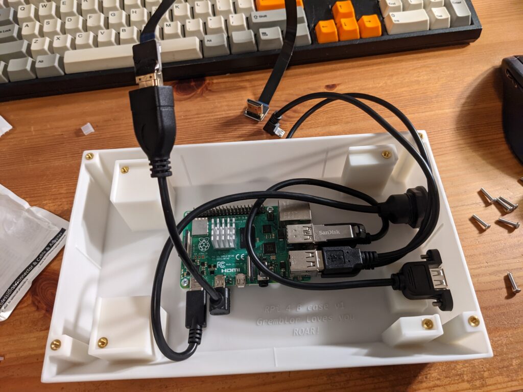 A Raspberry Pi in a 3-D printed case, with USB and HDMI cables attached to the Pi.
