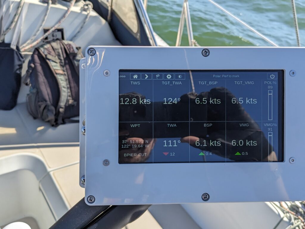 A close-up photo of an LCD display showing instrument data in the boat cockpit
